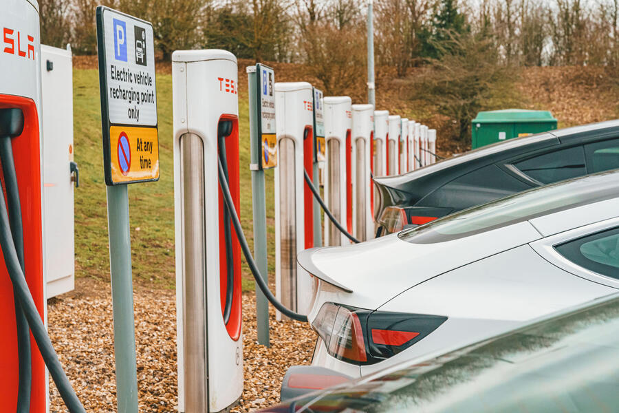 Teslas charging at Superchargers