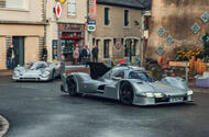 Porsche 963 RSP with 917 driving through town front quarter tracking Porsche 963 RSP with 917 driving through town front quarter tracking