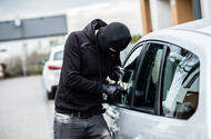 Thief breaking into car