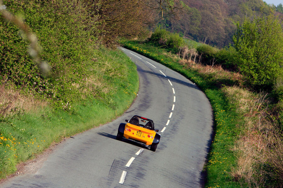 Westfield FW300 driving on a twisty countryside road, viewed from the rear