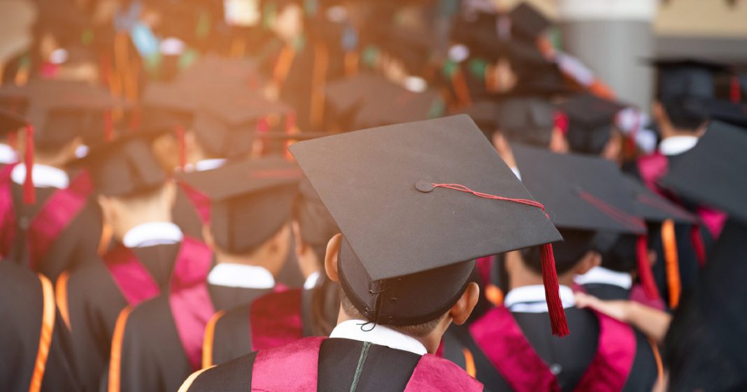 Students wearing graduation hats and gowns