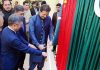 Imran Khan Cutting ribbon with Henan DR chairman. Pakistan and China Flags in background