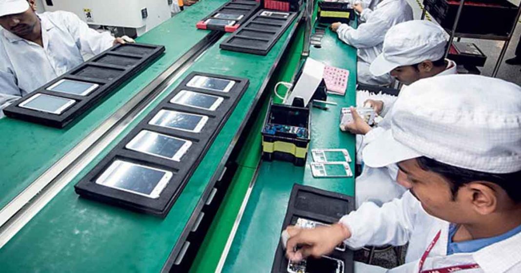 Pakistan LSM grows in March (Shows a factory with workers)