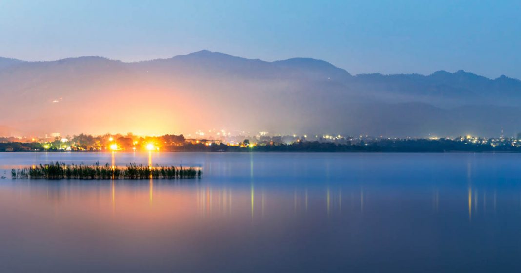 Rawal Dam Park shown with lights and mountain in the background