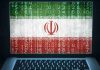 shows a laptop with Iranian Flag and a cyber attack happening