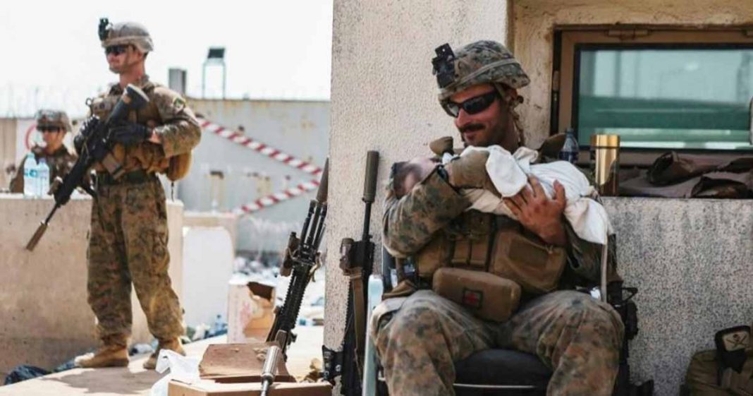 US Marine aiding baby