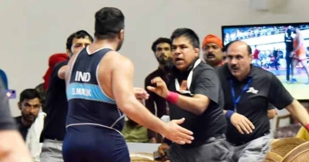 Indian wrestler punching referee