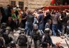 Israeli police beat mourners